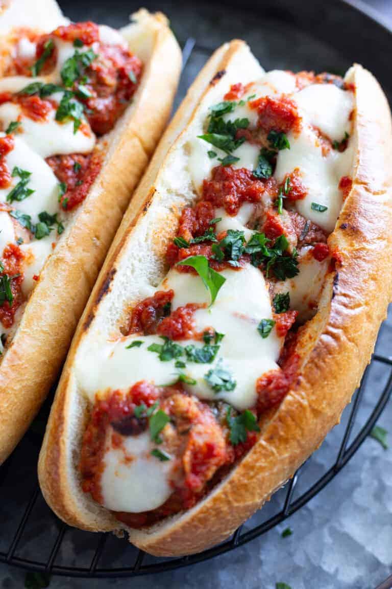 A meatball Parm hero with melted cheese and marinara sauce.