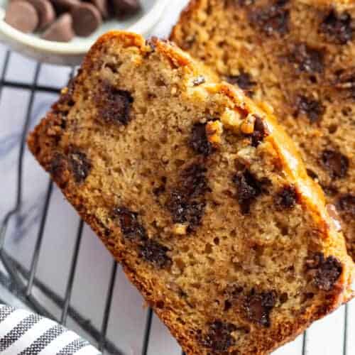 Sliced chocolate chip banana bread with 2 bananas.