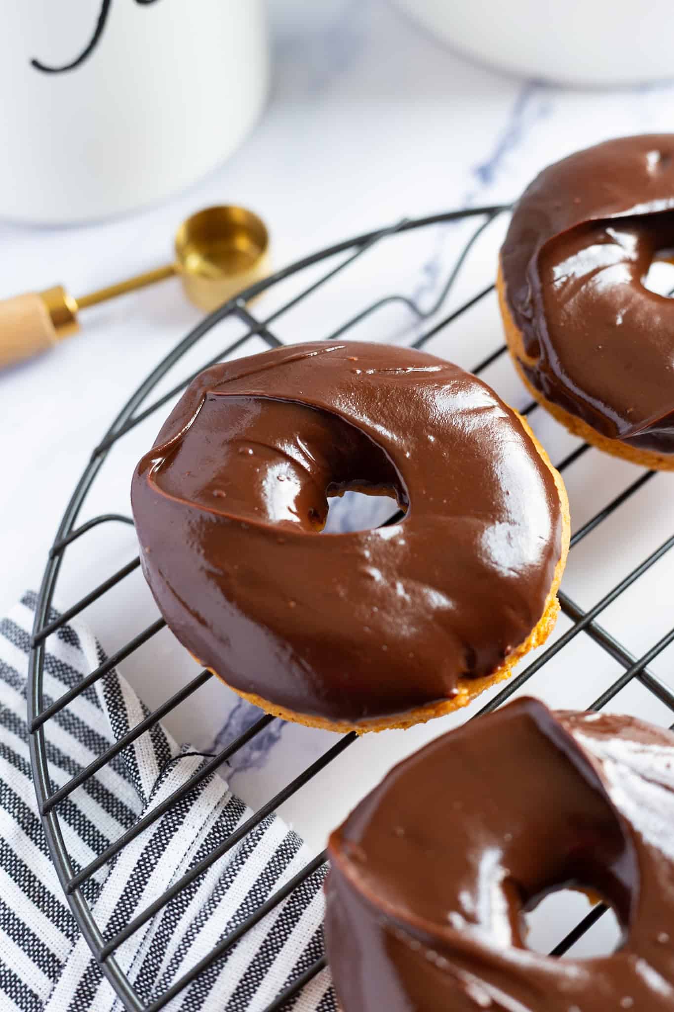 Baked pumpkin spice donuts dipped in chocolate glaze.