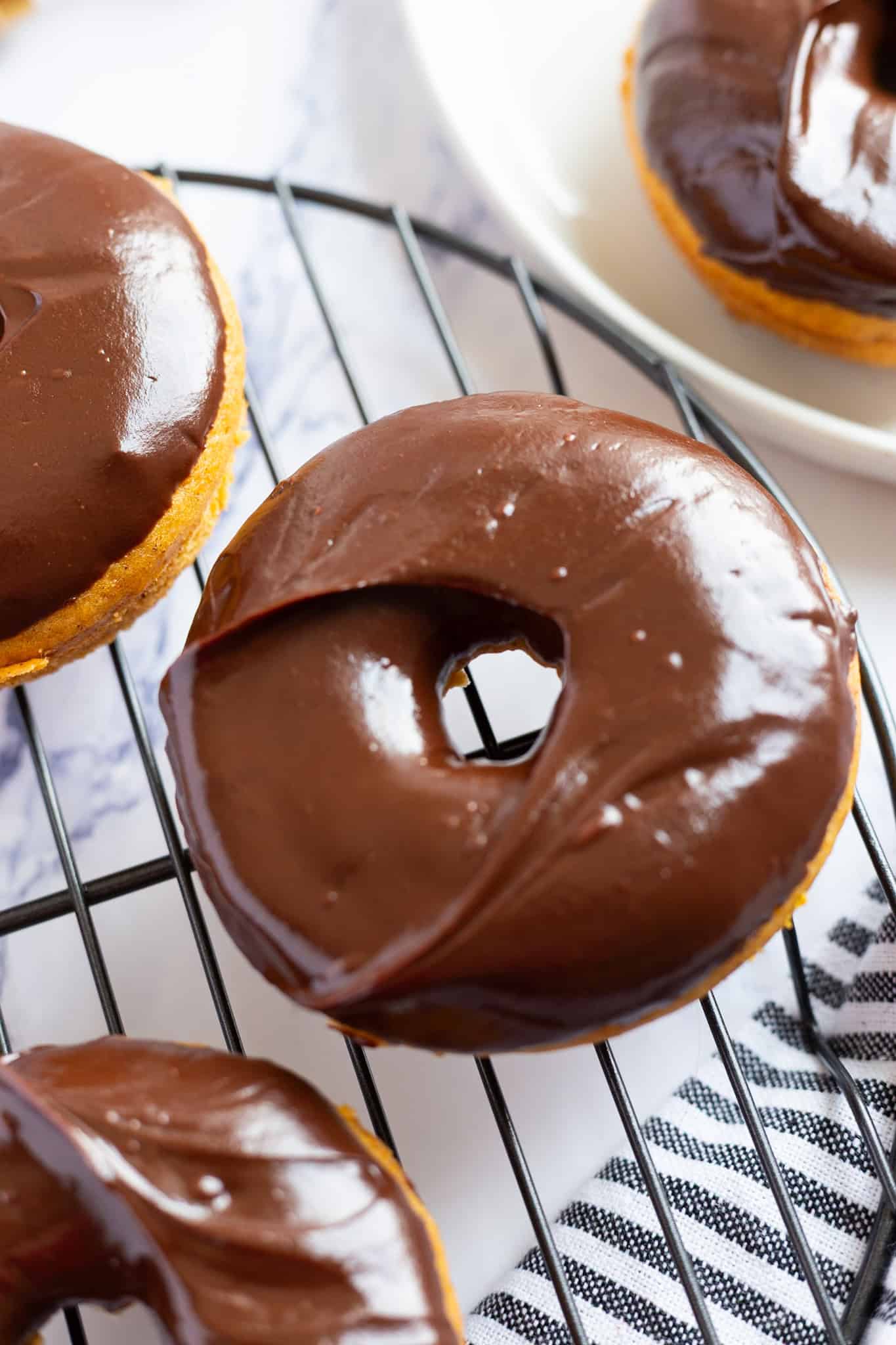 Baked pumpkin spice donuts with chocolate glaze.