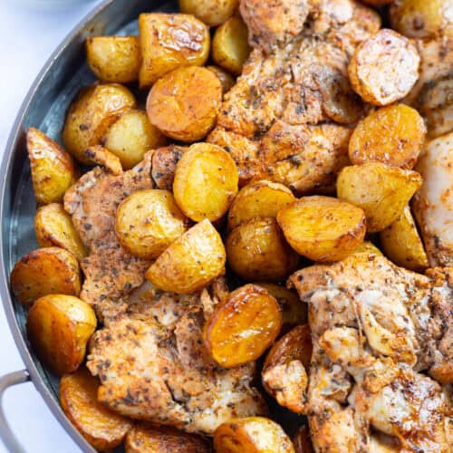 A platter of a baked vinegar chicken recipe with potatoes.