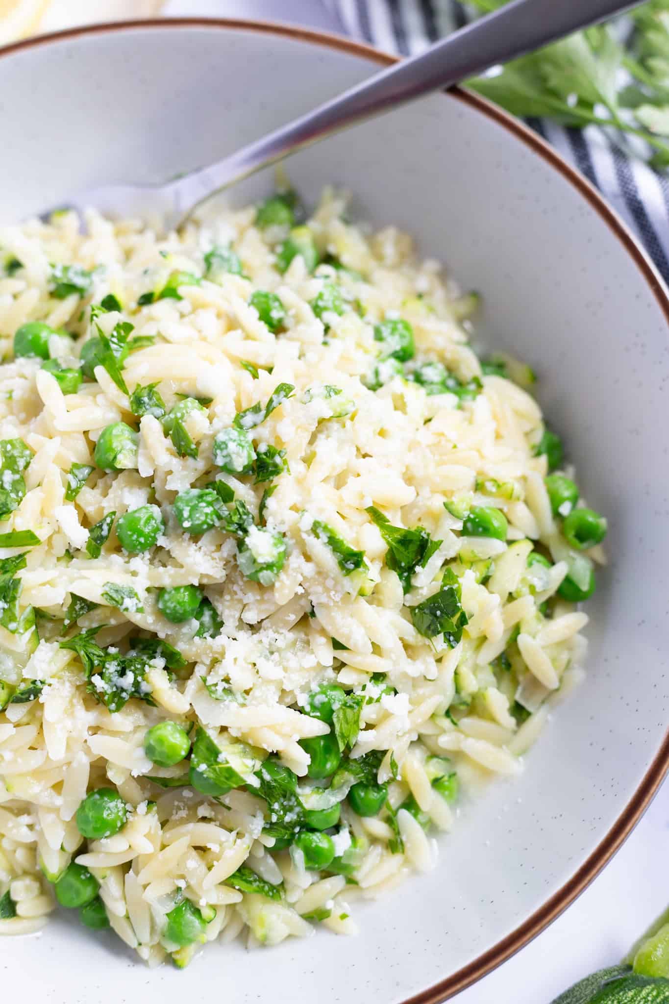 Lemon zucchini pasta garnished with grated Parmesan.