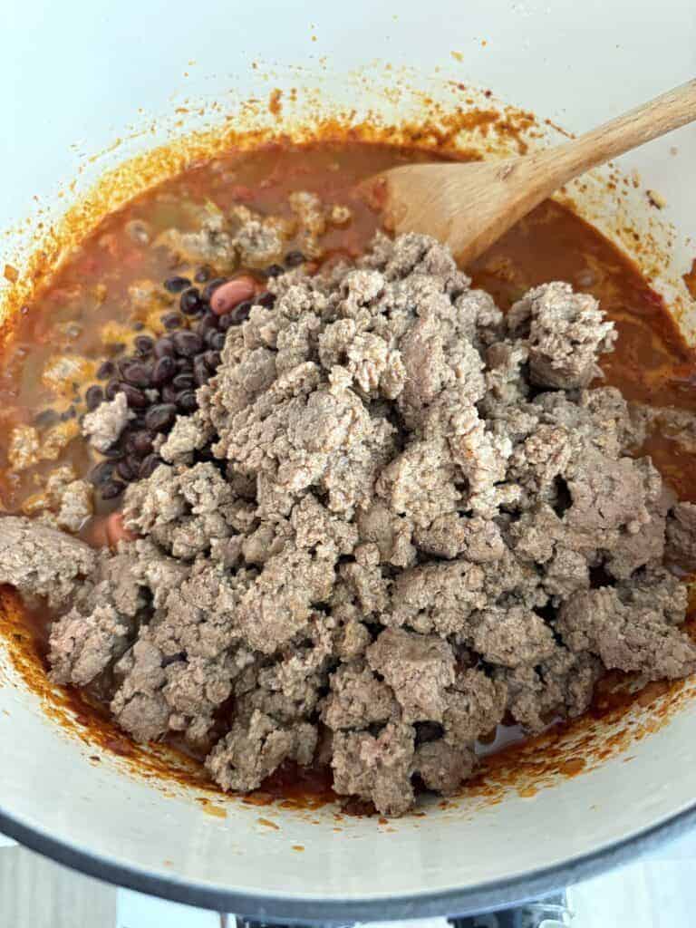 A pot of chili with ground turkey and beans added.