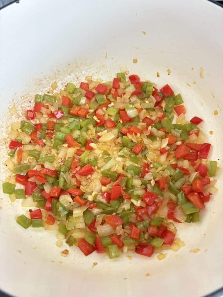 A pot of cooked peppers, onions, and garlic.