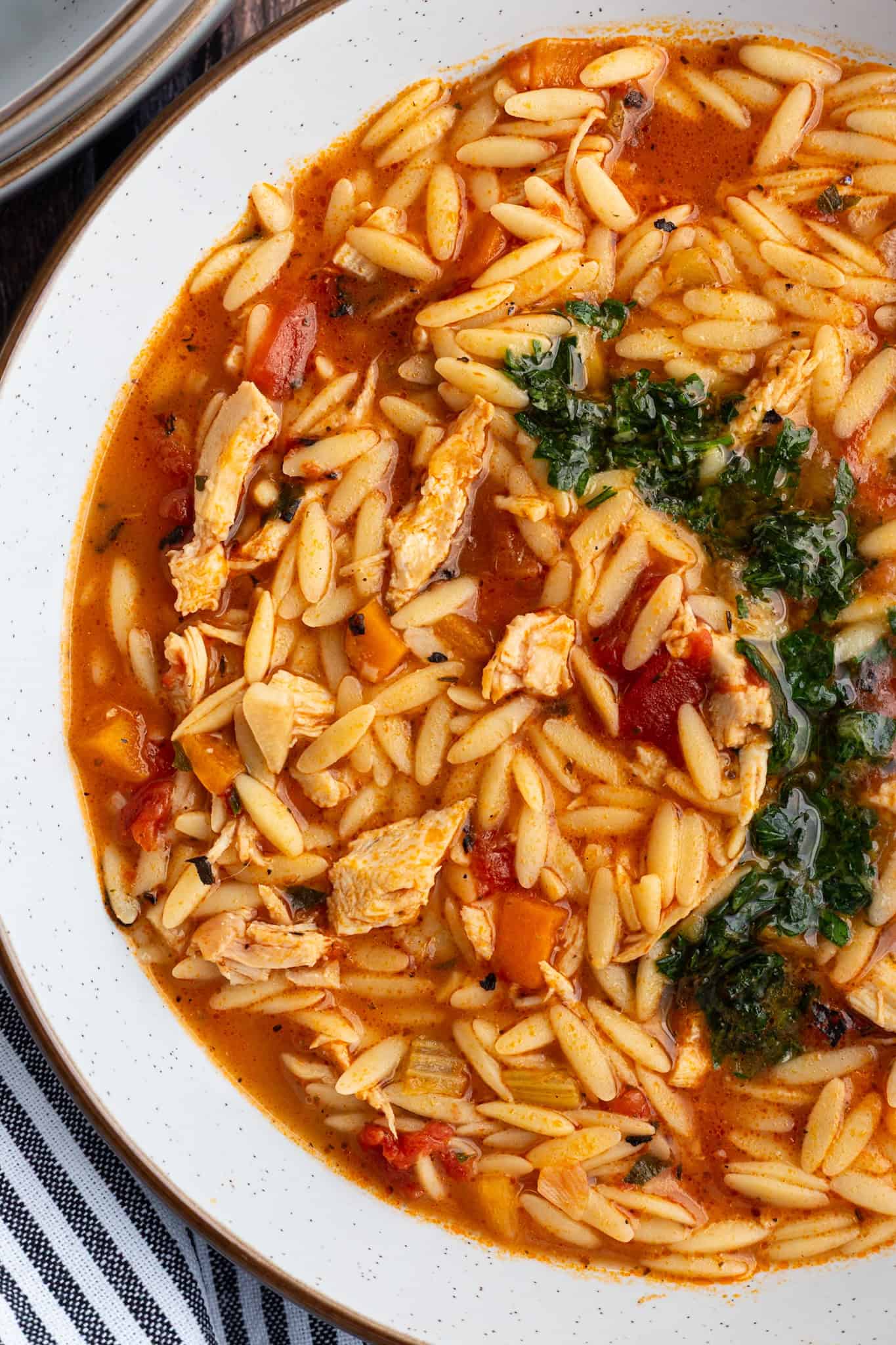 A bowl of turkey orzo soup with gremolata.