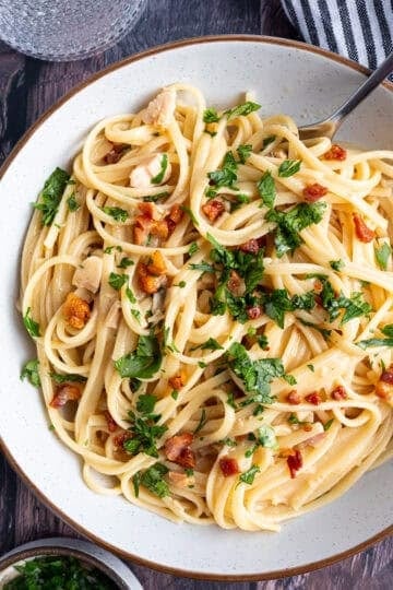 A bowl of pasta with crispy pancetta.