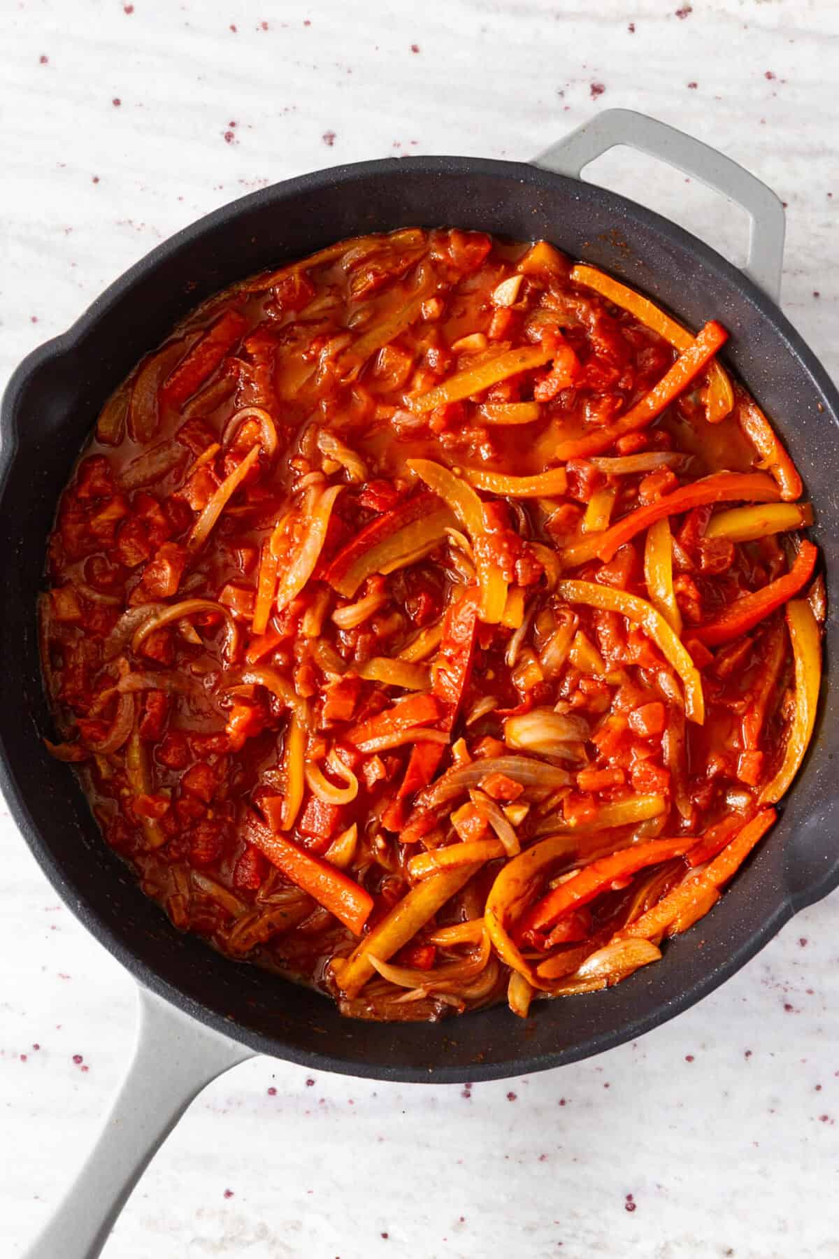 A pan of cooked peppers and tomatoes.