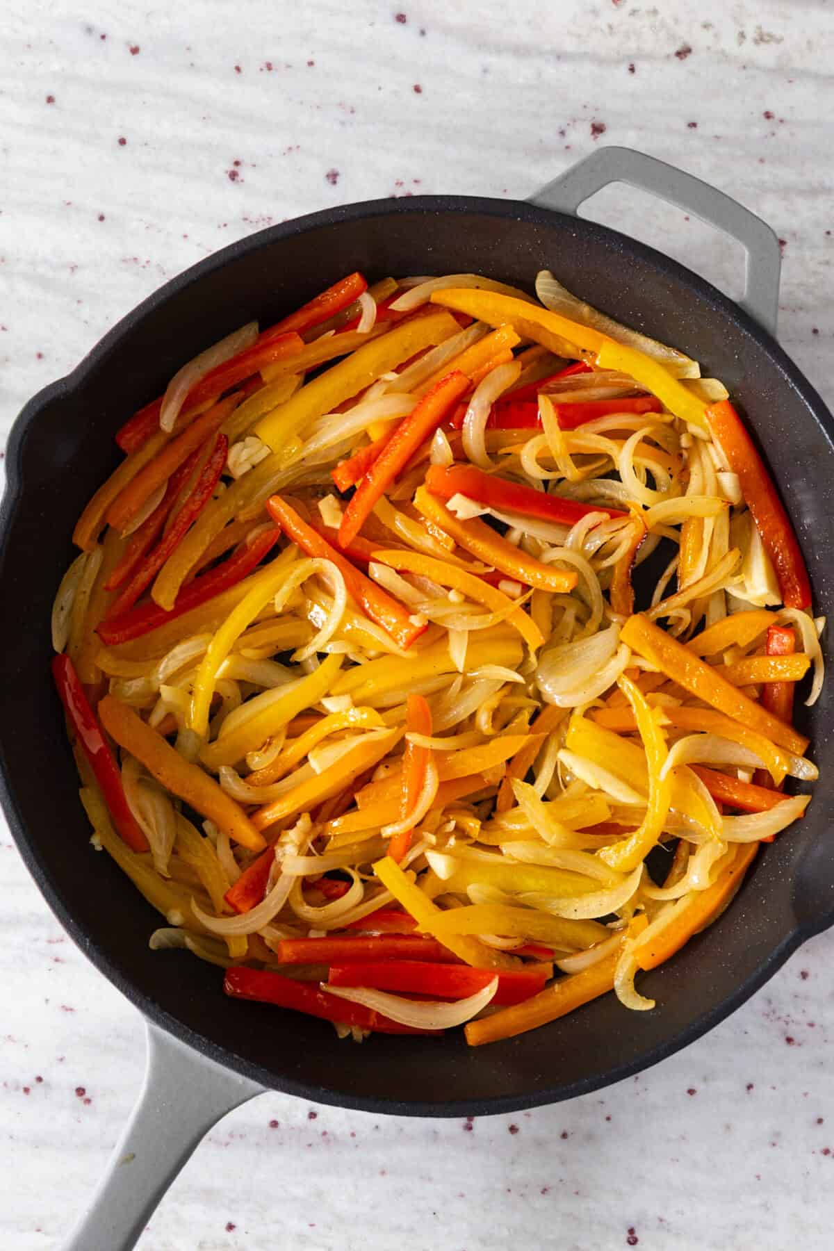 A pan of cooked peppers and onions.
