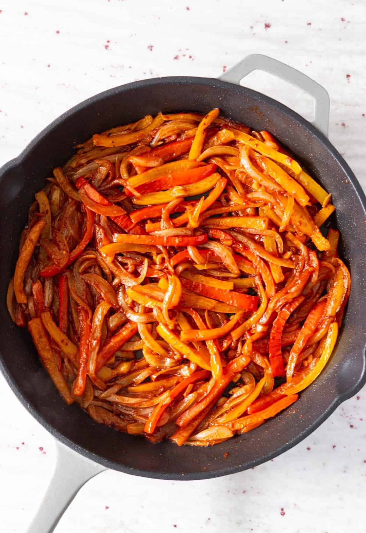 A pan of peppers and onions simmered in wine.