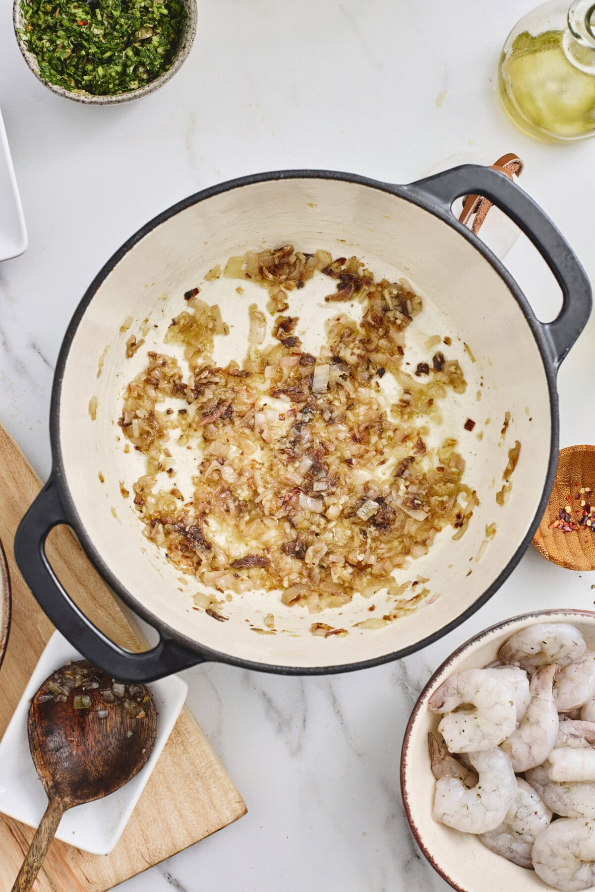 A pot of cooked garlic, onions, and anchovies.