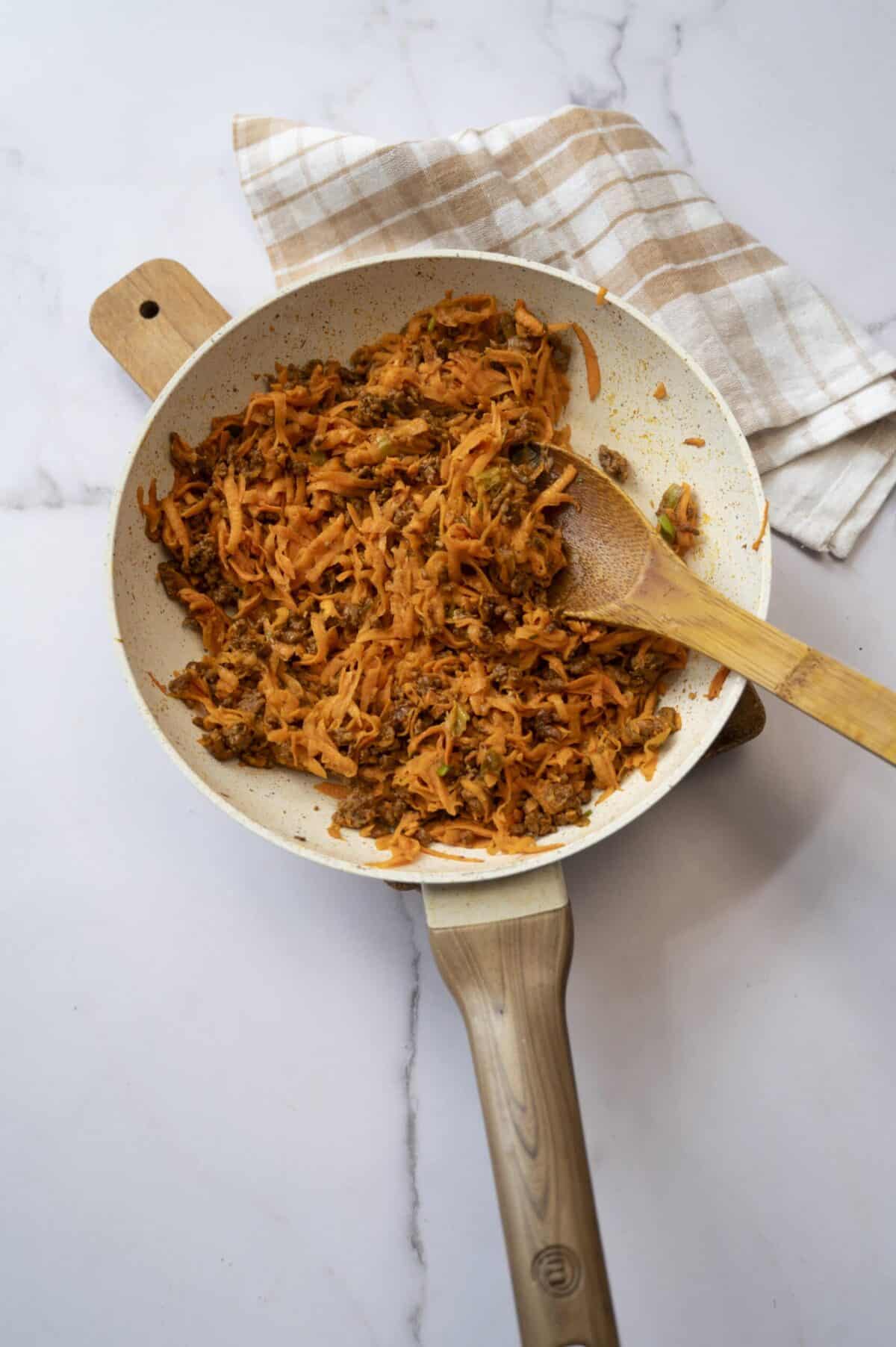 Cooked shredded sweet potato and chorizo.