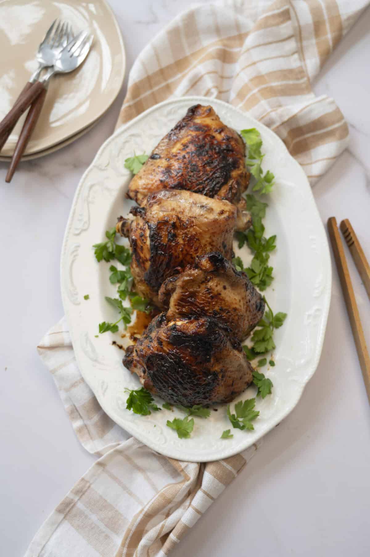 A platter of grilled bone-in chicken thighs.