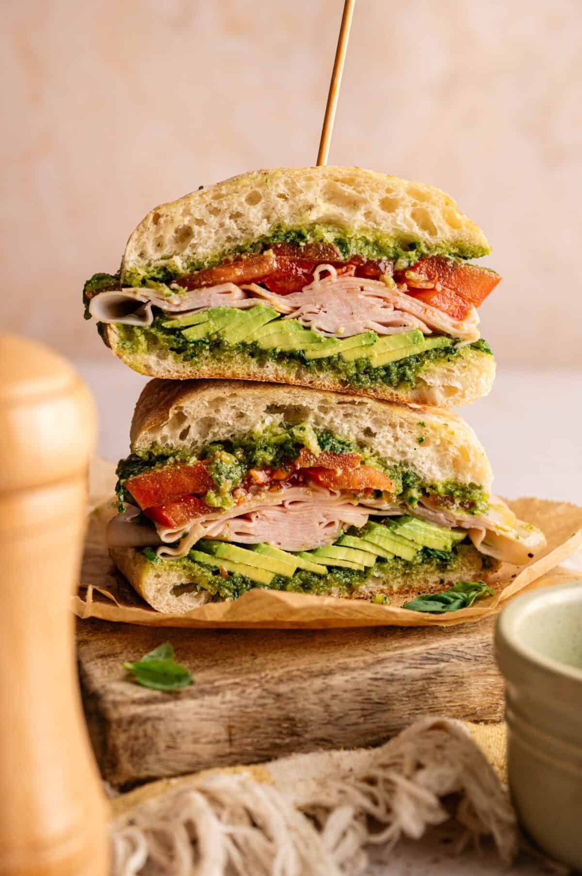 A sliced and stacked smoked turkey sandwich.