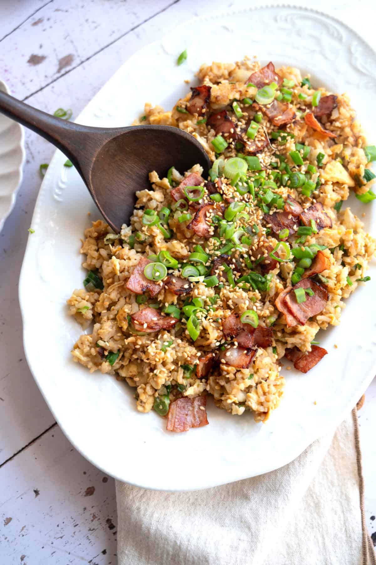 A platter of fried rice with a serving spoon.