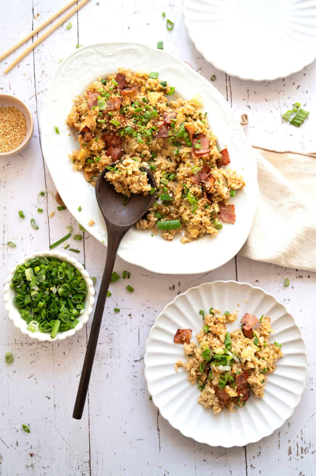 Bacon and egg fried rice garnished with scallions.