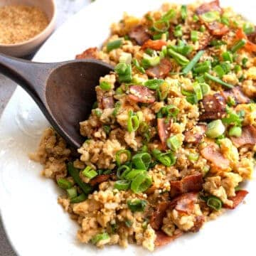 A platter of bacon and egg fried rice.