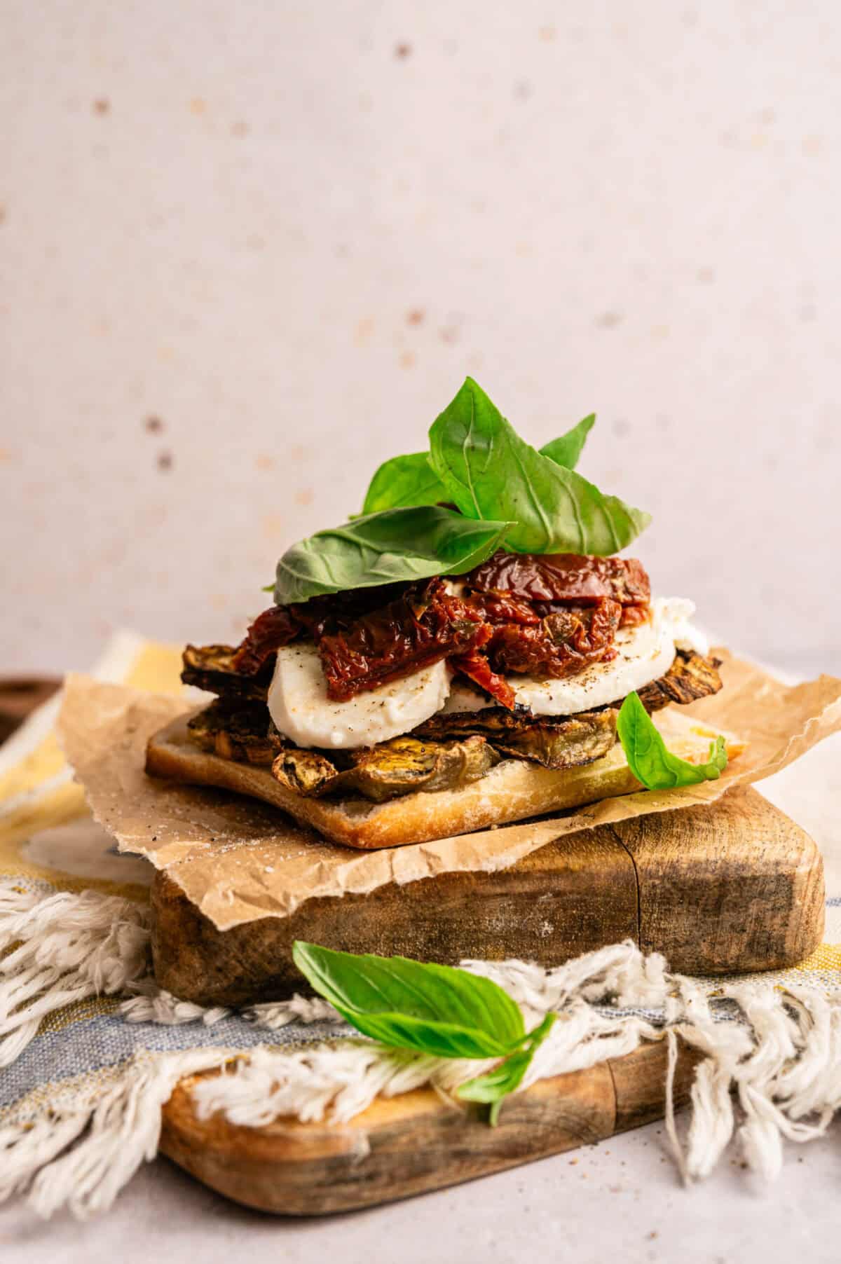 A roasted eggplant sandwich being assembled.