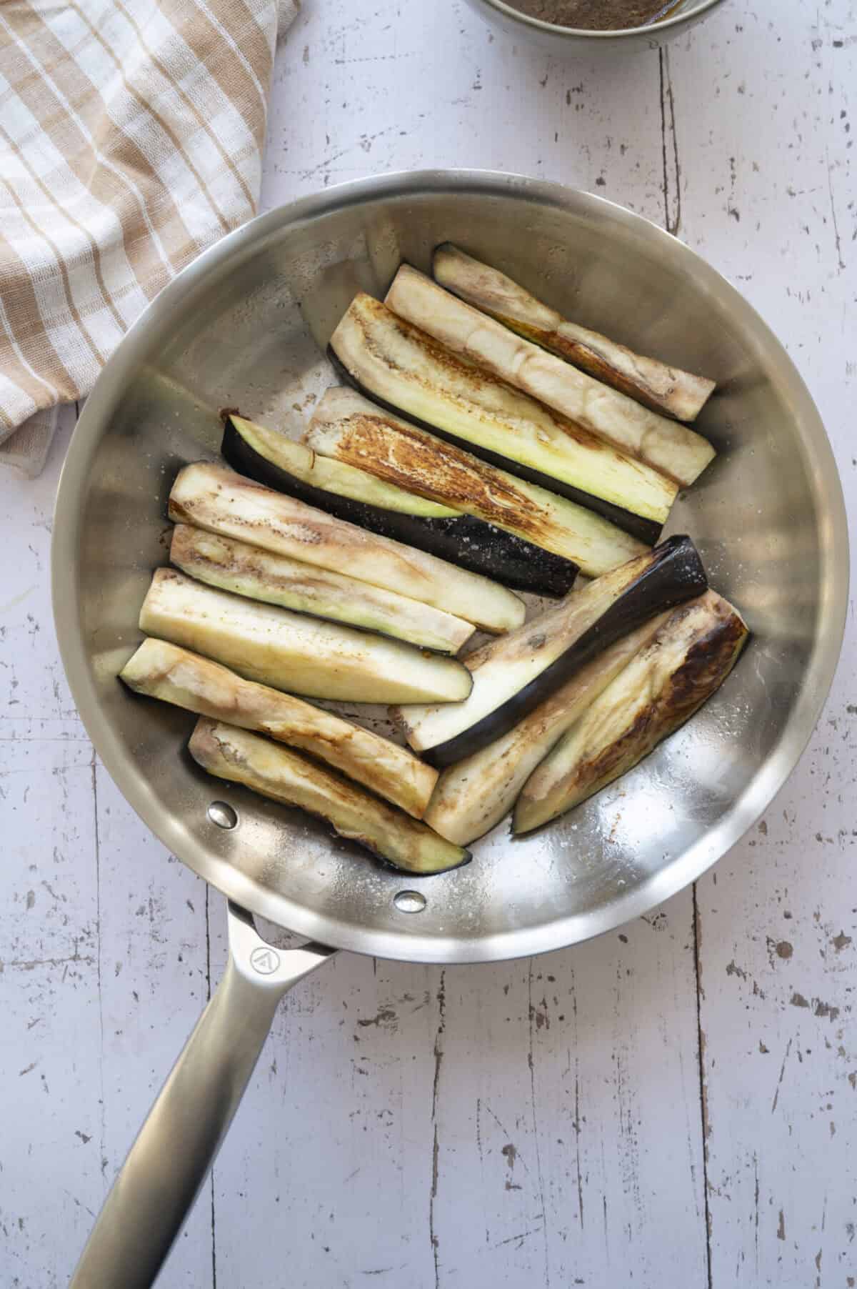 A pan of partially cooked eggplant.