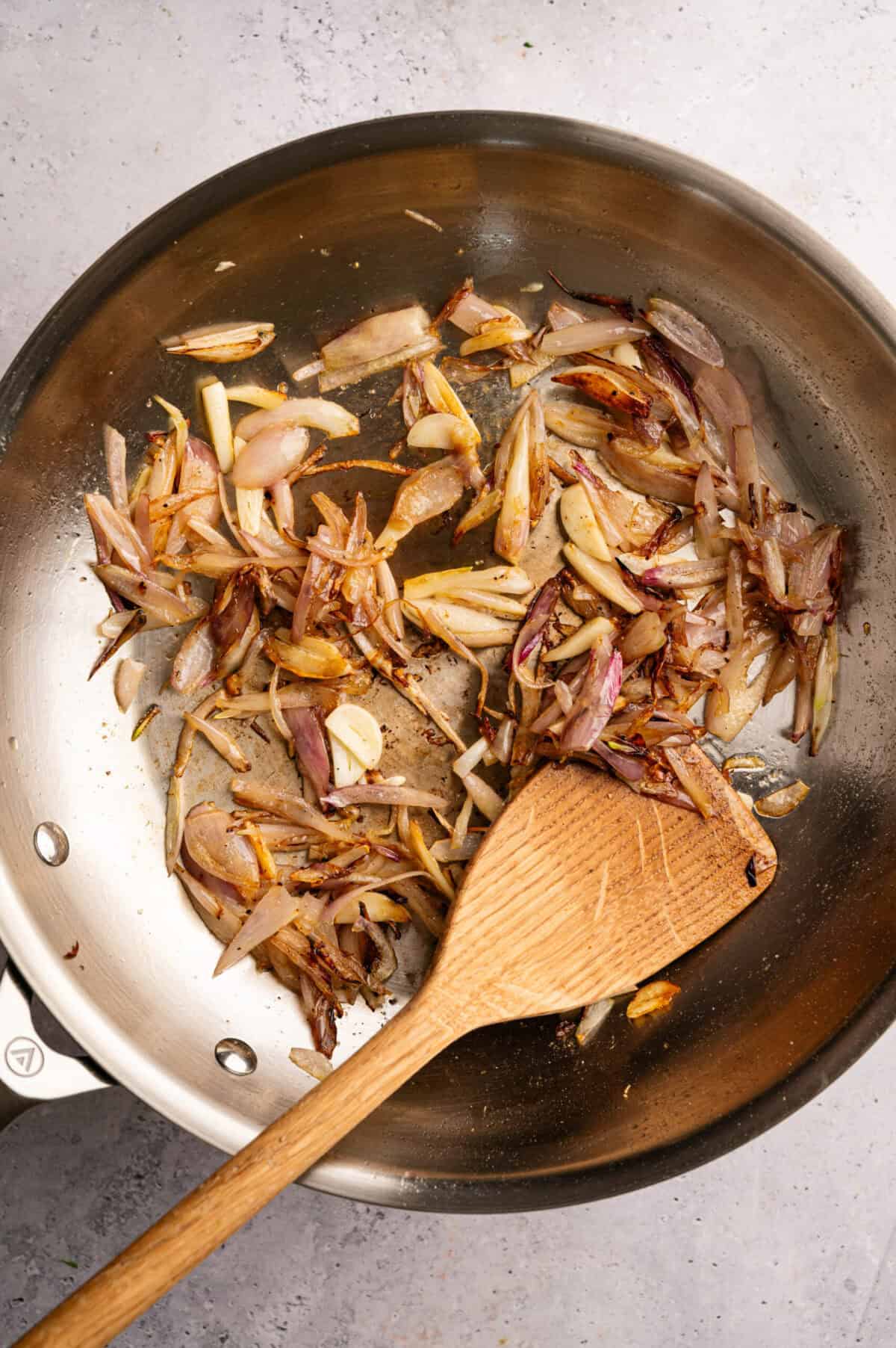 A pan of cooked shallots and garlic.