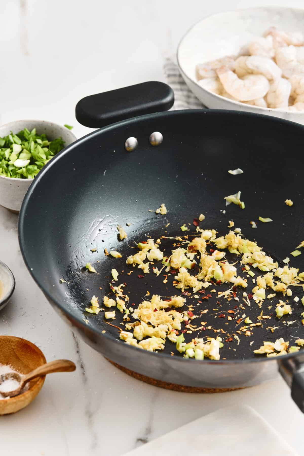 A pan of sauteed garlic, ginger, and scallions.