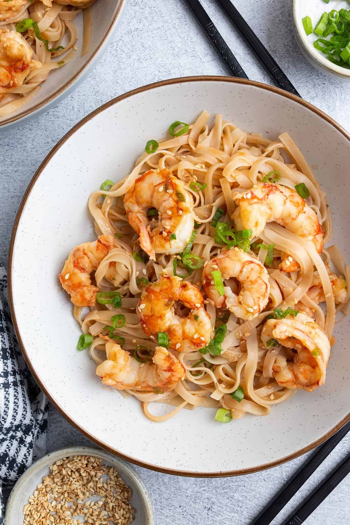 A bowl of rice noodles tossed with shrimp.