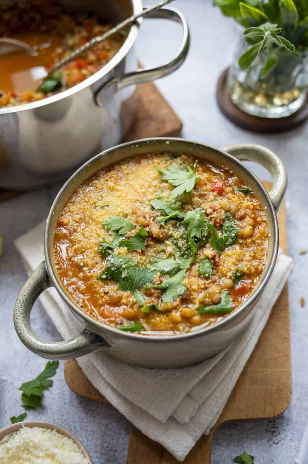 A bowl of lentil and barley soup topped with Pecorino.