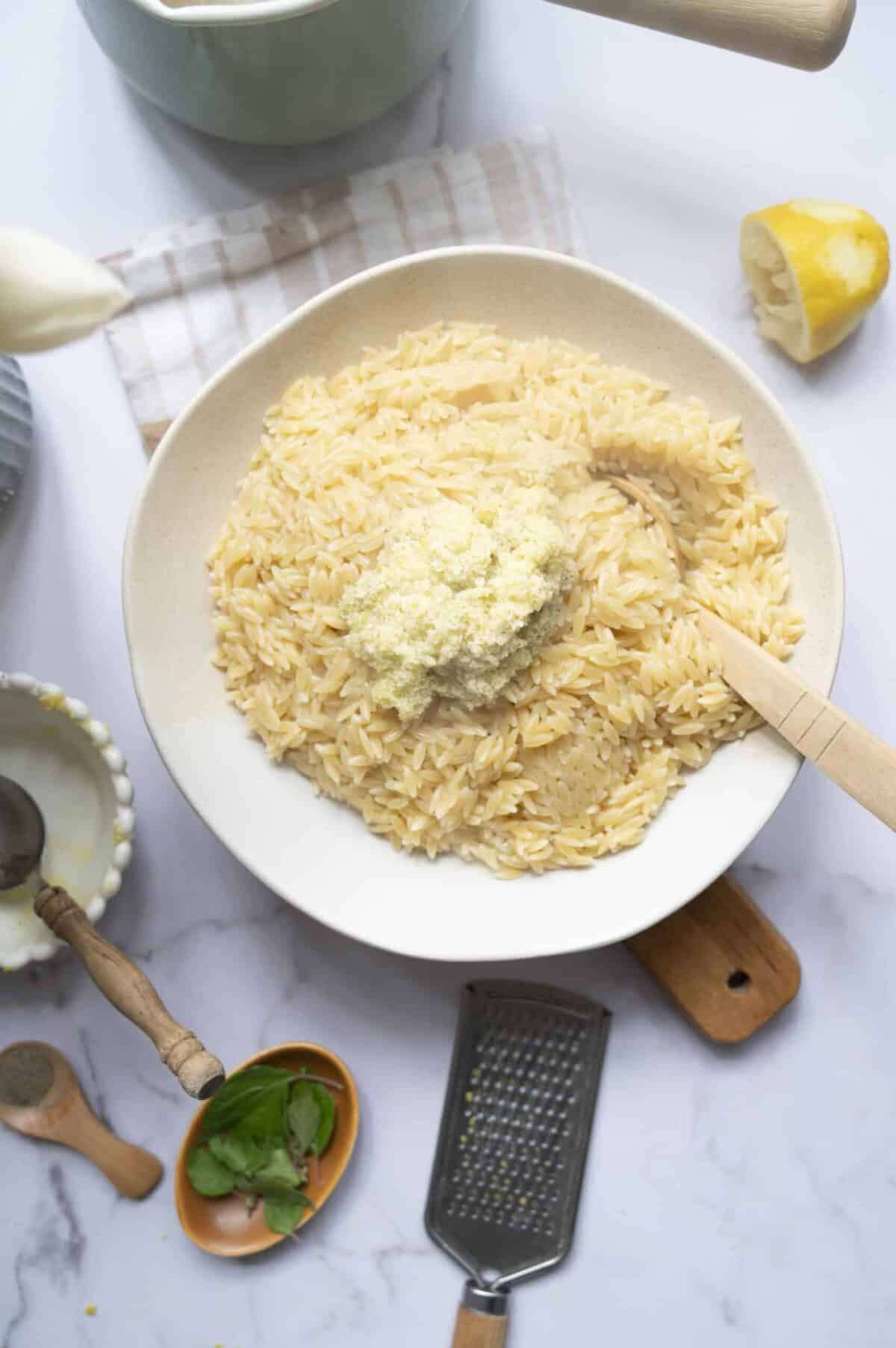 A bowl of orzo tossed with a lemon and olive oil dressing.