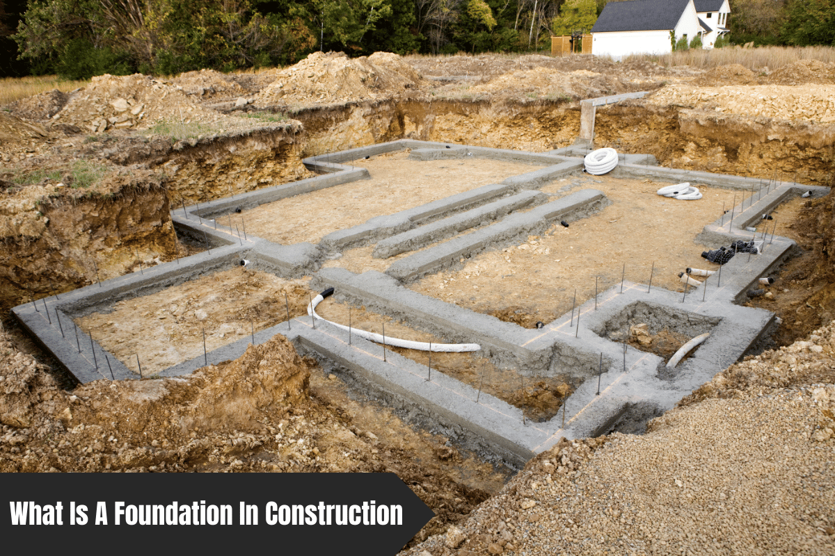 Concrete foundation being poured for a new house in a dug-out pit.