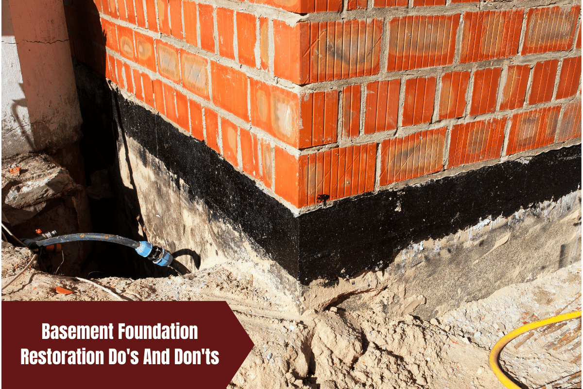 Brick wall with black waterproofing layer on a basement foundation.