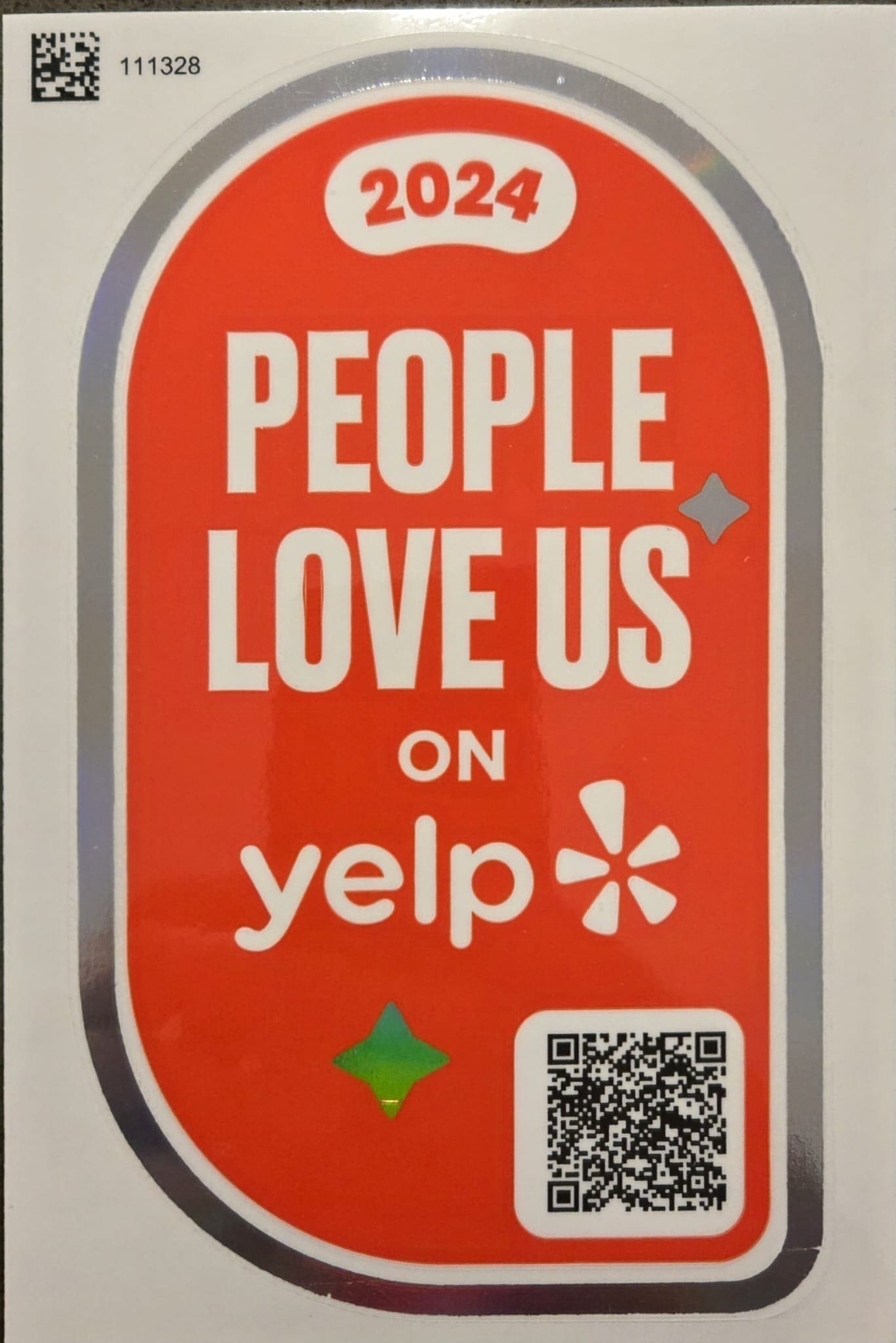 Red and white 'People Love Us on Yelp' sticker with 2024 and QR code