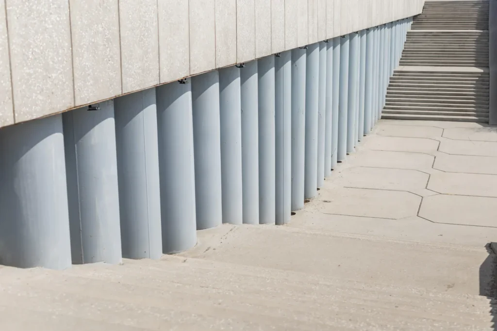 Concrete wall with vertical gray columns and a wide staircase