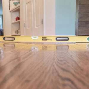 Yellow level tool on a wooden floor in a room