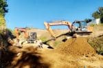 Excavators working on road construction site in New Zealand.