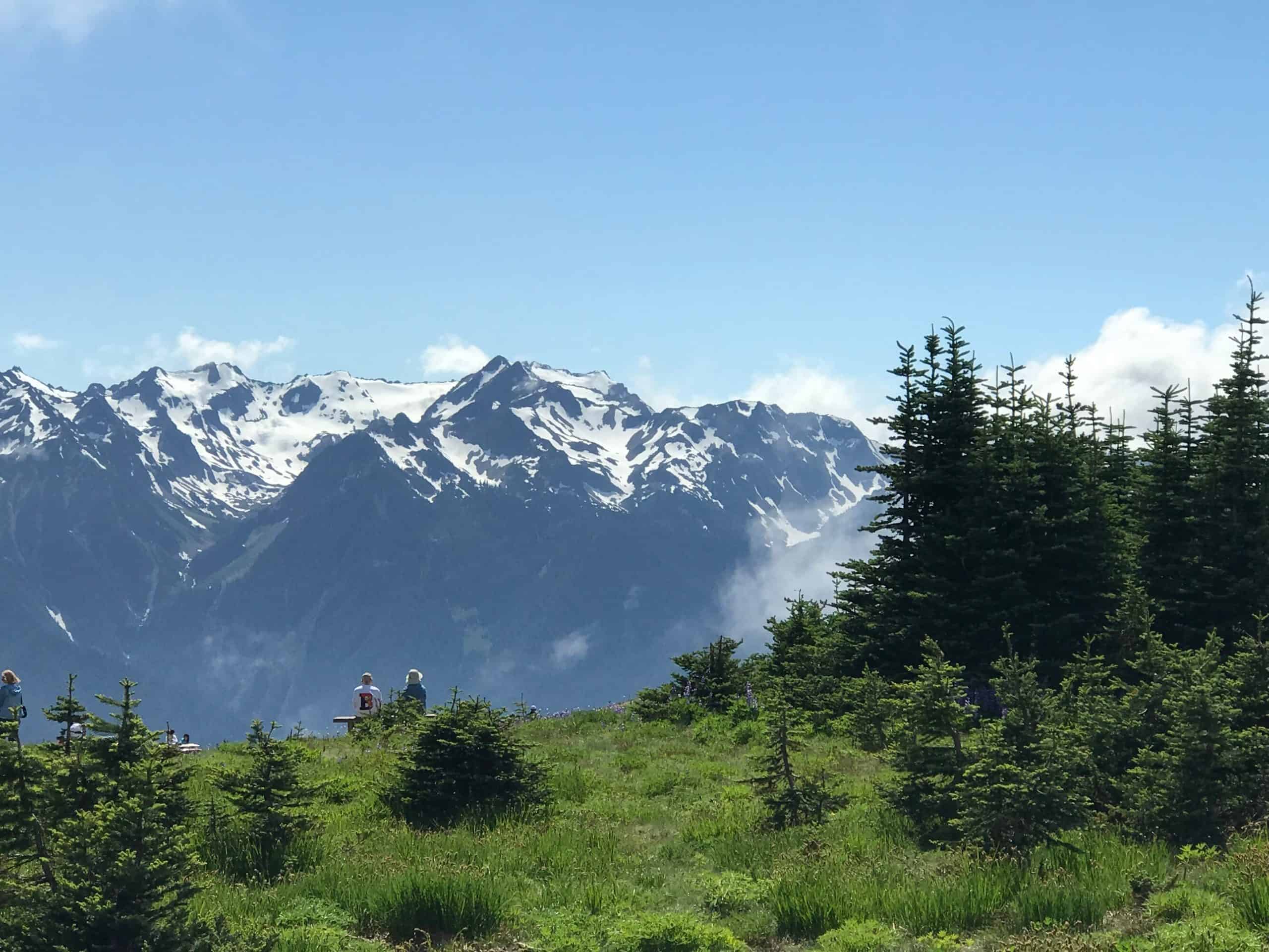 A mountain ridge and couple enjoying calm and peace of mind.