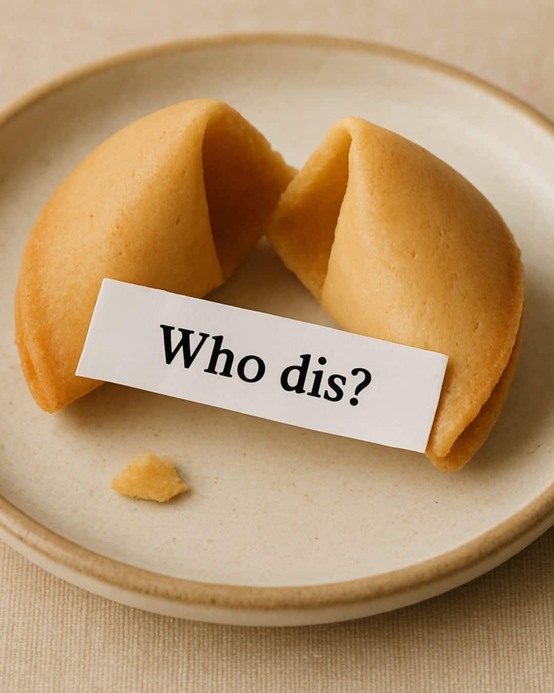 A cracked open fortune cookie on a plate with a fortune reading: who dis, hinting towards a modern twist on the practice of self-inquiry.