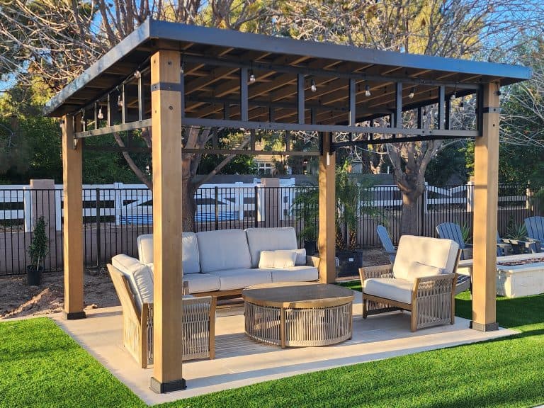 Beautiful backyard pergola with comfortable seating, perfect for outdoor living and landscape design.