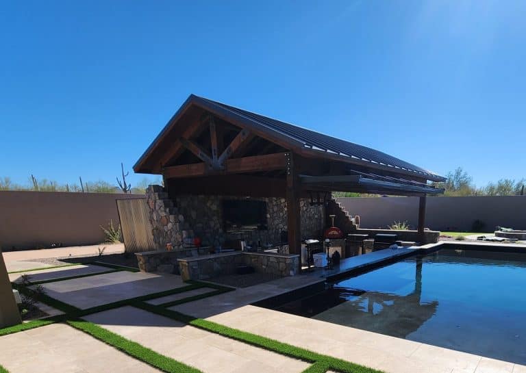 Stylish backyard with pool, covered patio, and stone accents, ideal for landscape and outdoor living projects.