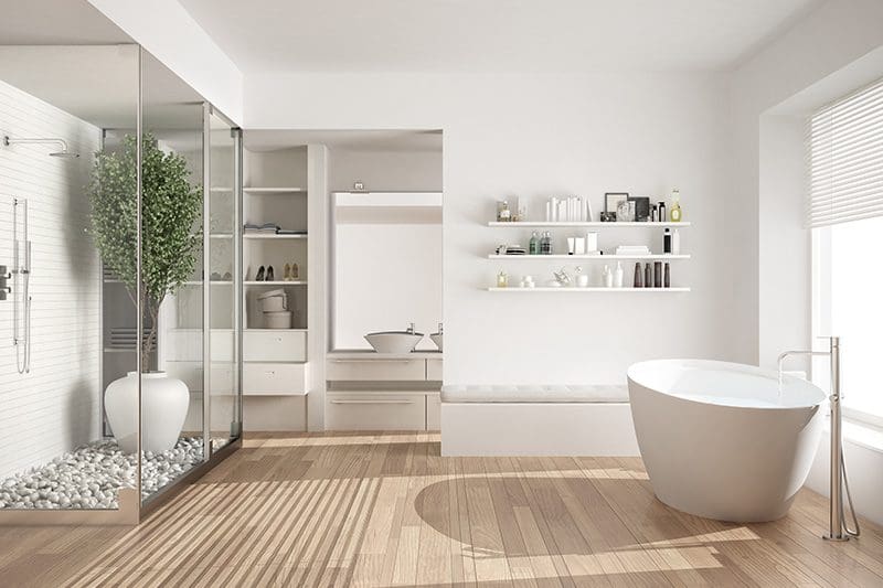 Modern bathroom with glass shower, freestanding tub, and white shelves