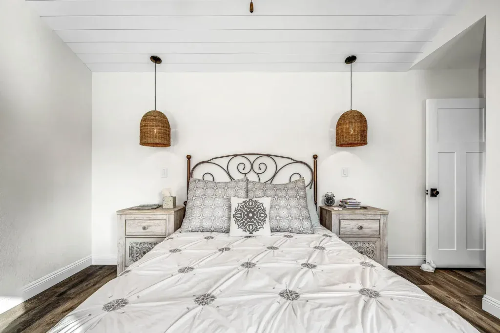Bedroom with a bed, two nightstands, and two hanging lamps