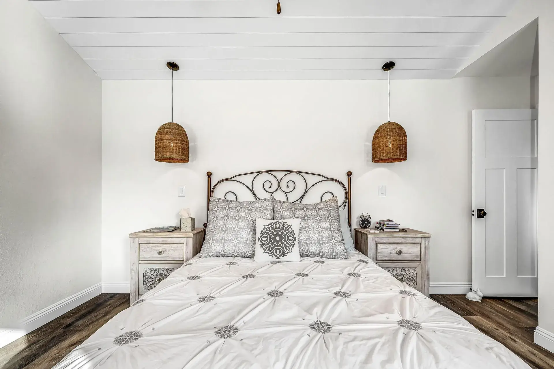 Bedroom with a bed, two nightstands, and two hanging lamps