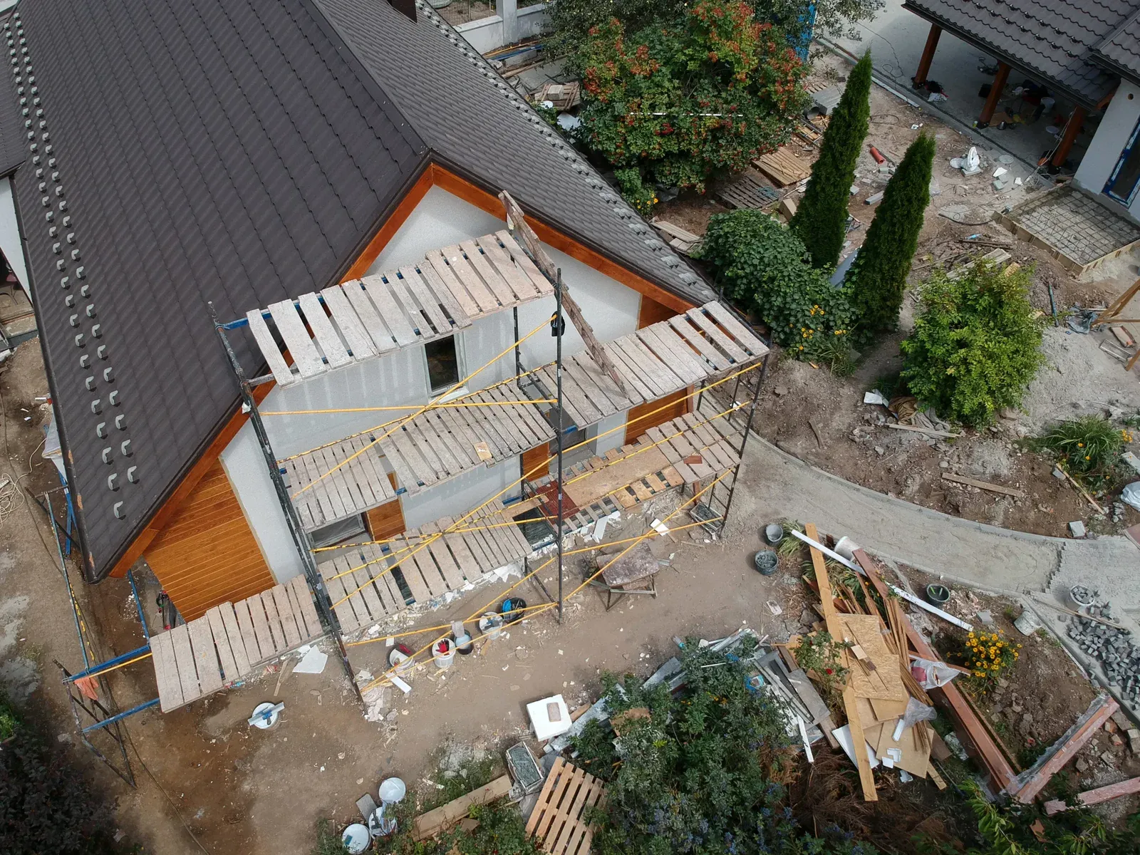 Aerial view of a house under construction with scaffolding