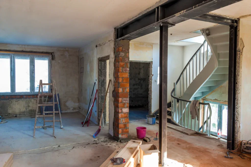 Interior of a house under renovation with exposed brick and metal beams