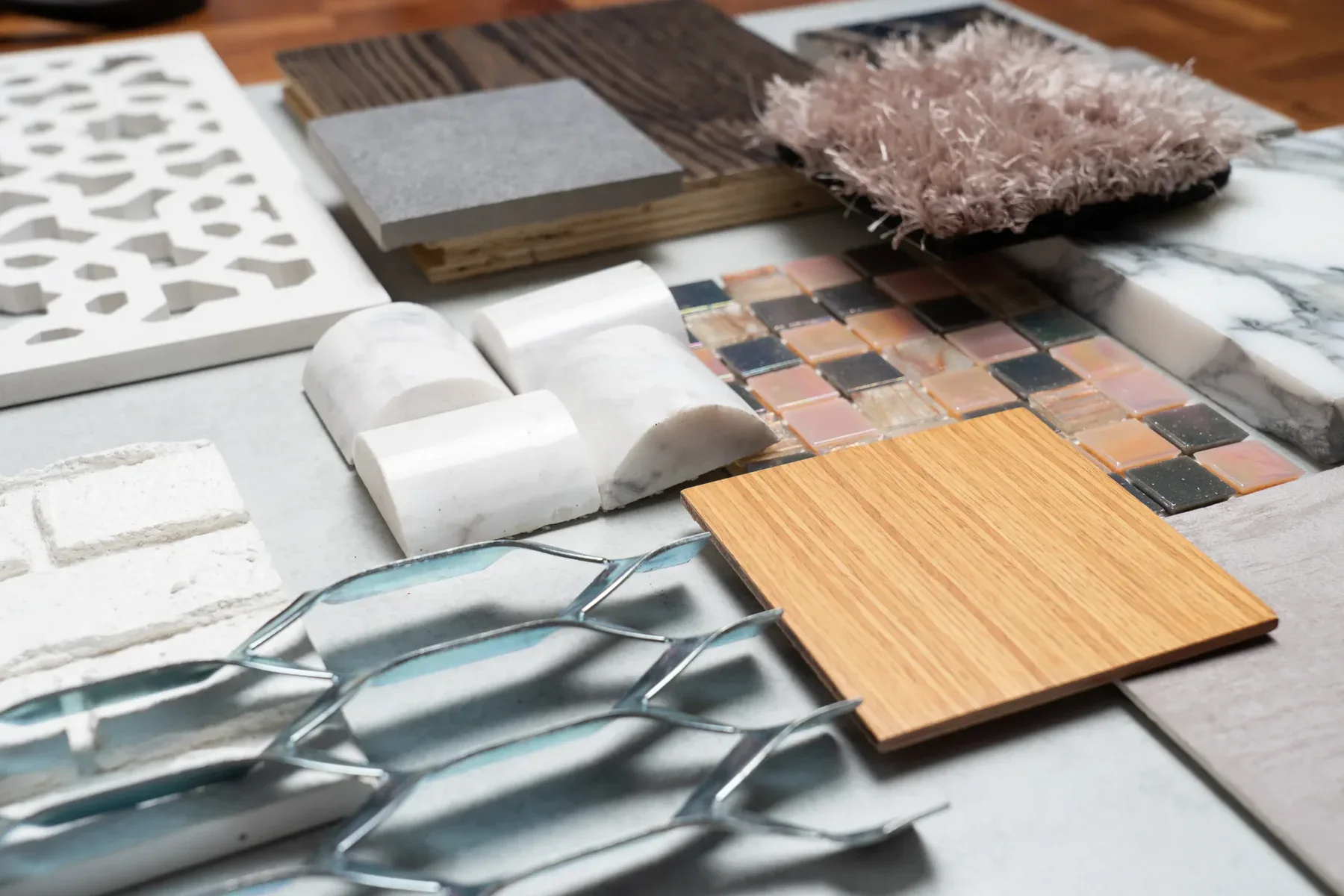 Various material samples for interior design, including wood, tile, fabric, and metal.
