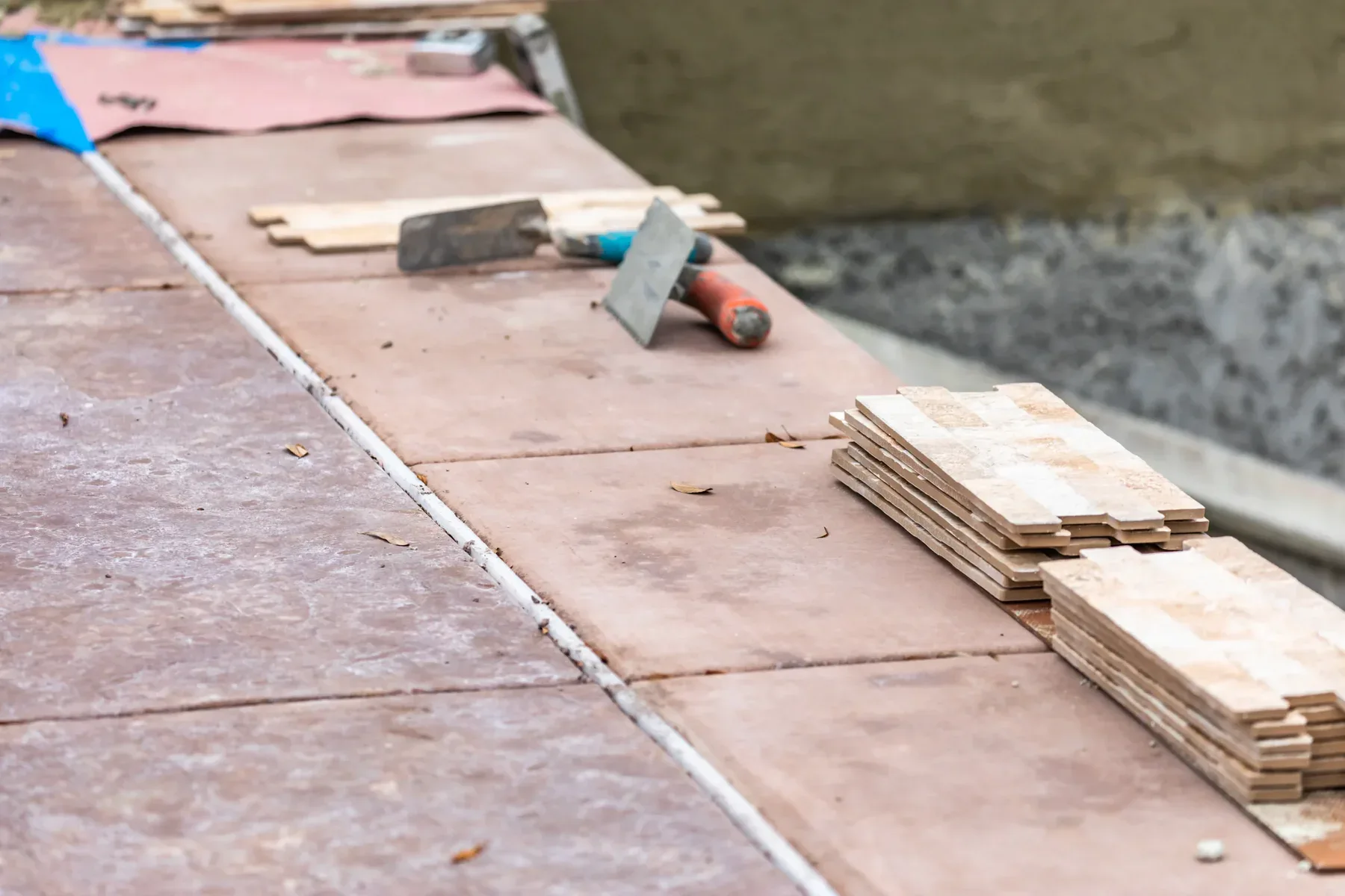Tiling tools and tiles on a partially tiled surface