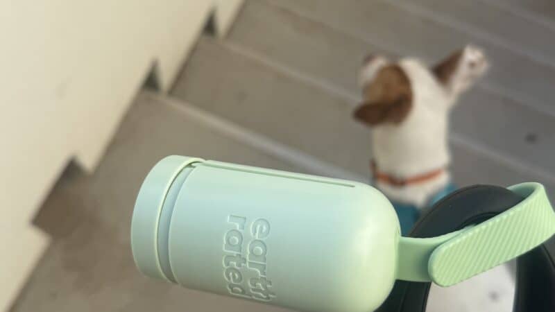 taking dog out with leash and bag dispenser