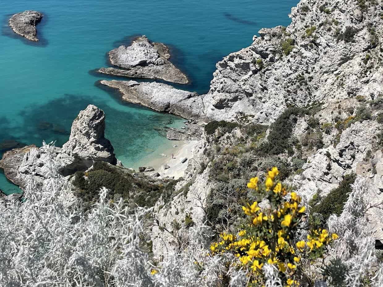 Scenic view of cliffs and turquoise waters at Capo Vaticano, Italy.