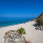 Deserted White sand beach with blue sea and sky