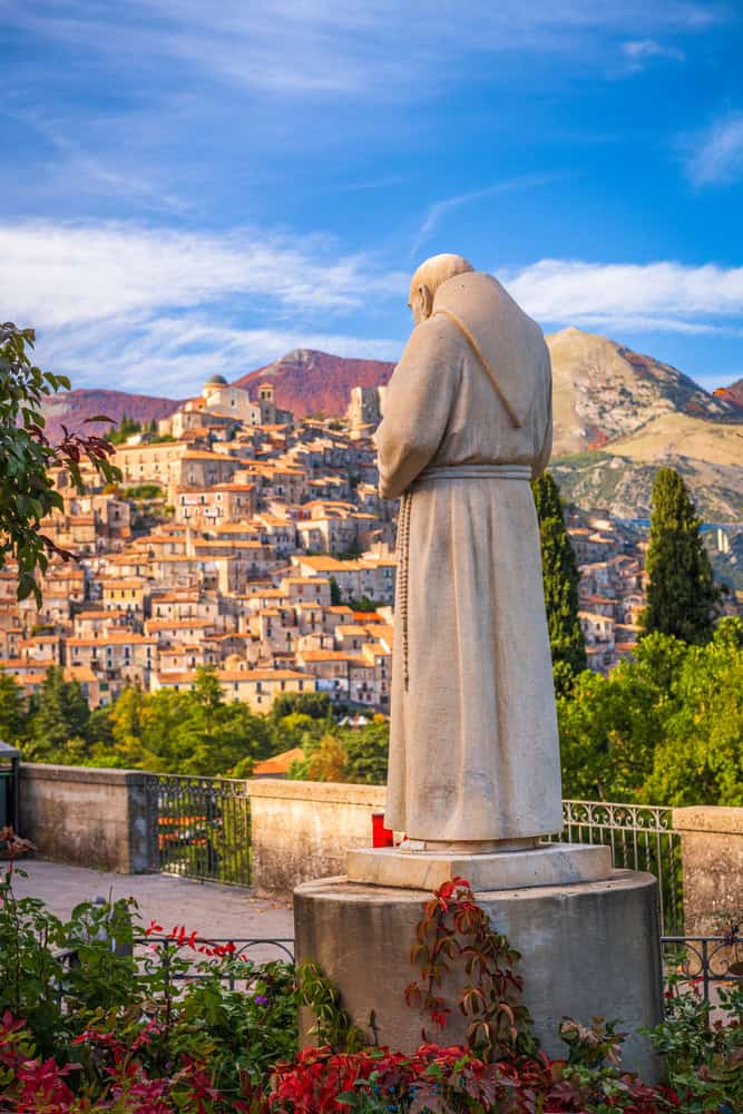 Distant view of the village of Morano Calabro from a Terrace with a Stone statue