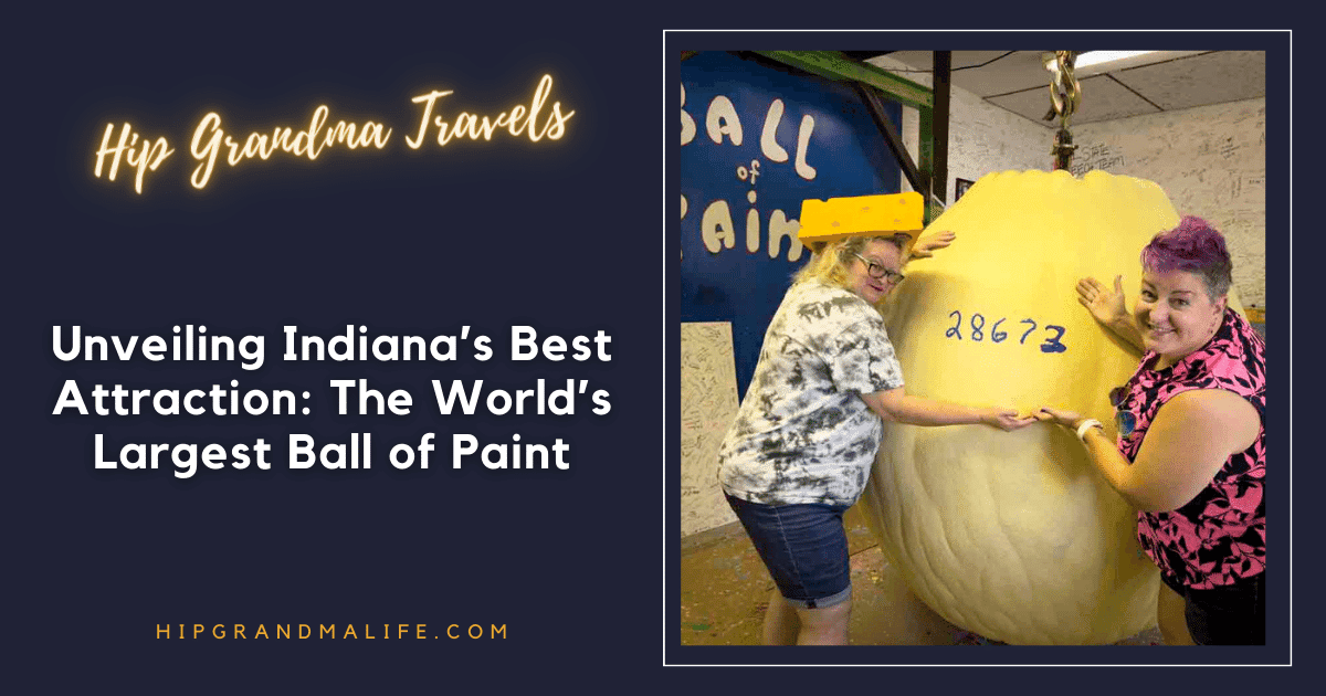 Huge yellow ball of paint being displayed by two women at the world's largest ball of paint attraction.