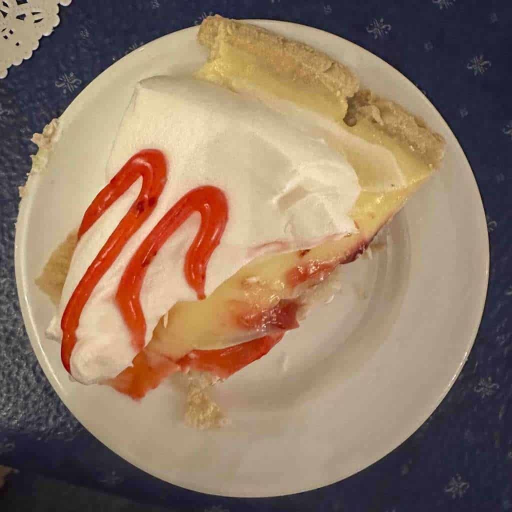 a round plate with a piece of homemade raspberry cream pie